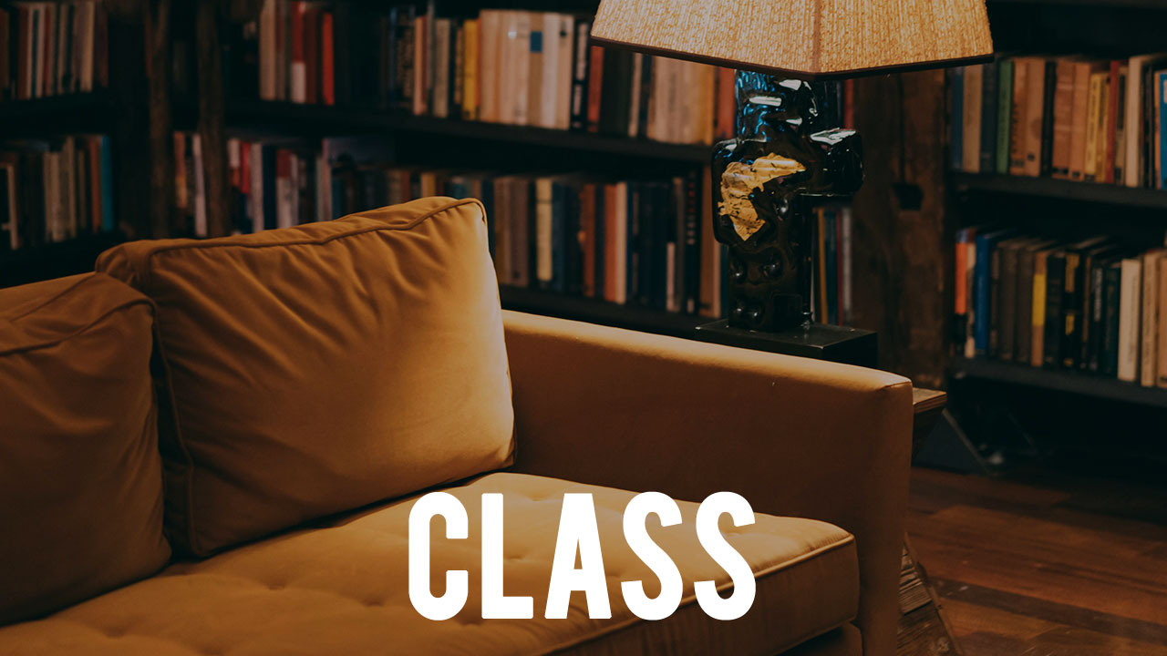 the word "CLASS" overlayed upon an image of a couch in a library with books on bookshelves in the background of the photo